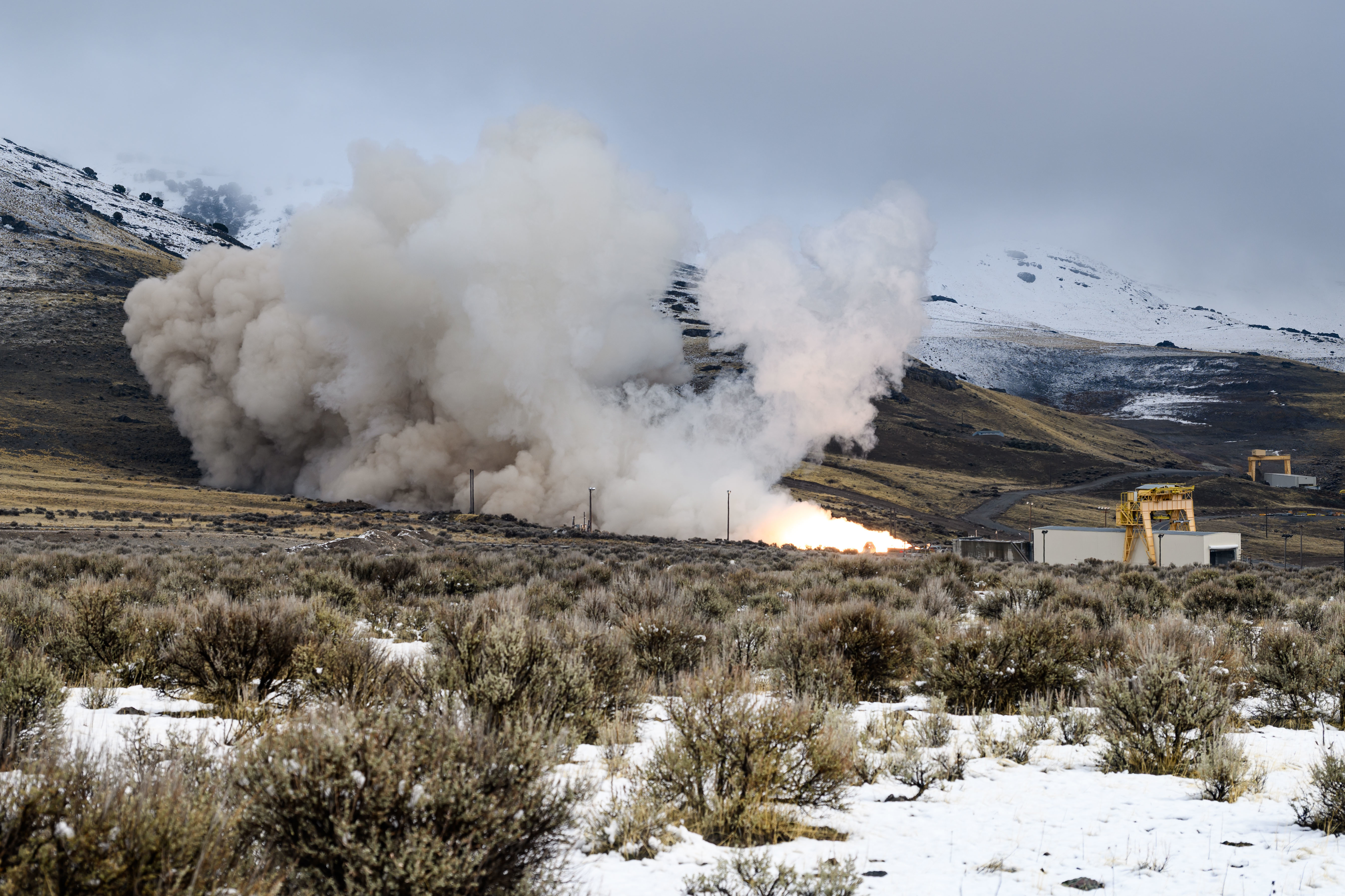 Test explosion and smoke plumes on hillside